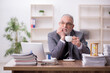 © Elnur - Old male employee drinking coffee during break
