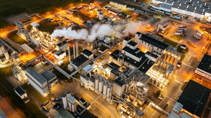 View of a heavily smoking factory at night, industrial area of the city of Wroclaw, Poland