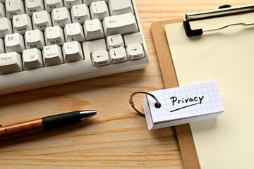Poster - there is word book with the word of privacy. it's on the desk with a clipboard and a keyboard.
