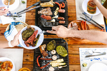 Wall Mural - group of Friend eating Mexican Tacos and traditional food, snacks and peoples hands over table, top view. Mexican cuisine	