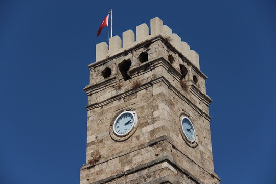 old turkish tower with clock on a blue sky background