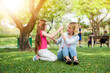 © amorn - Mother and her daughter playing in the garden in summer day, family concept