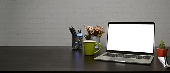 Fototapete - Mock up laptop computer, coffee cup and pencil holder on wooden table with brick wall.