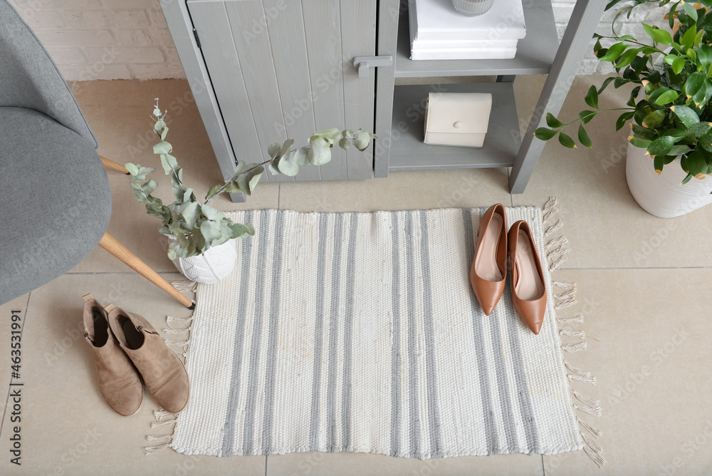 Stylish rug on floor in interior of hallway