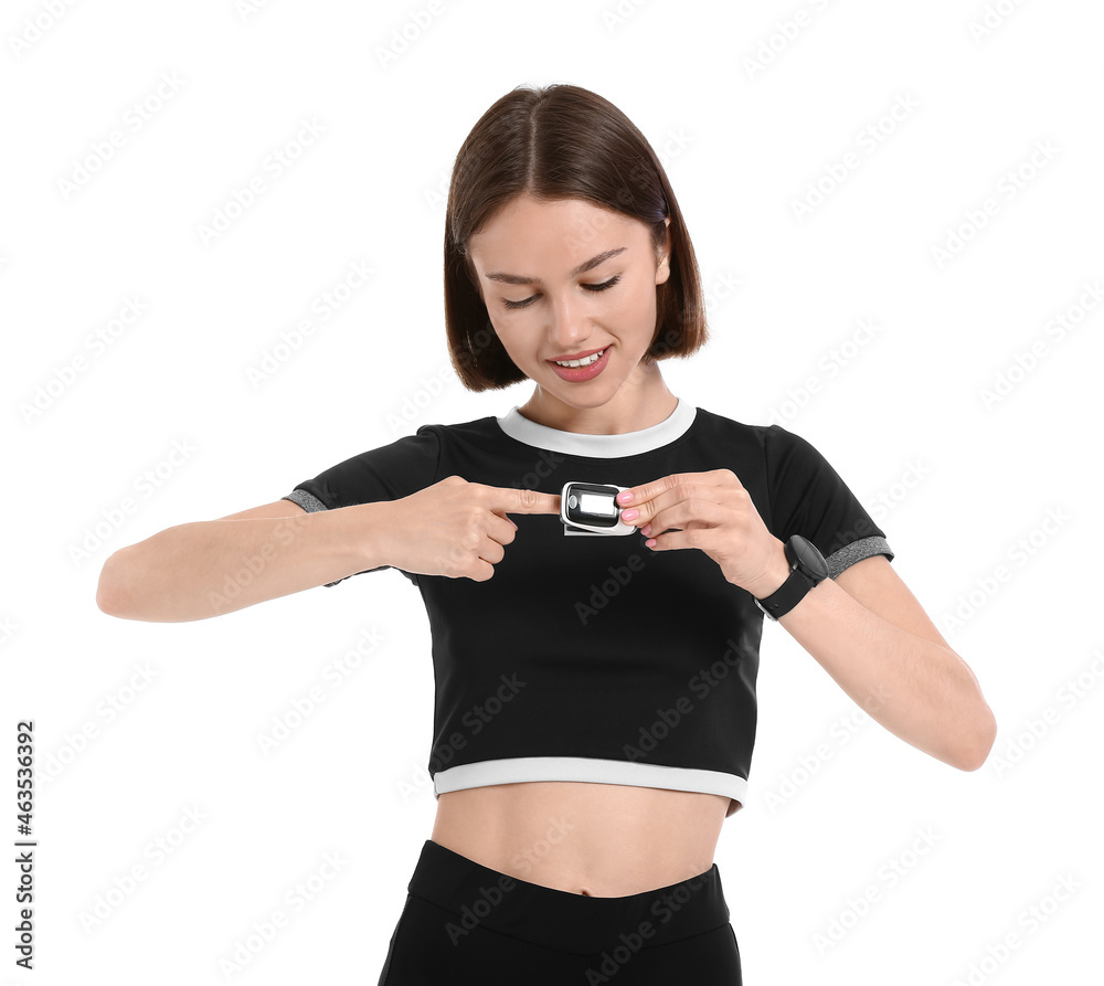 Sporty young woman with pulse oximeter on white background