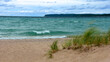 a stunning view across the turquoise-colored water of lake michigan  from the beach at sleeping  bear point in sleeping bear dunes national lakeshore in the lower peninsula of michigan