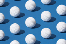 Arranged White Golf Ball On Blue Pastel Background. Minimal Design.