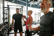 © Svitlana - Attractive and sporty senior couple training in gym