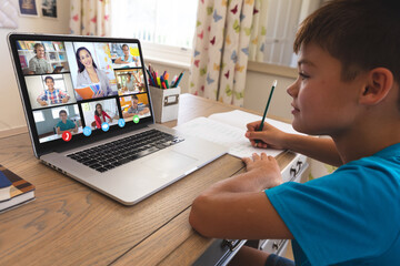 Poster - Caucasian boy using laptop for video call, with smiling diverse high school pupils on screen