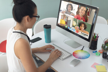 Poster - Asian girl holding computer for video call, with smiling diverse elementary school pupils on screen