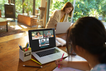 Sticker - Asian girl using laptop for video call, with smiling diverse elementary school pupils on screen