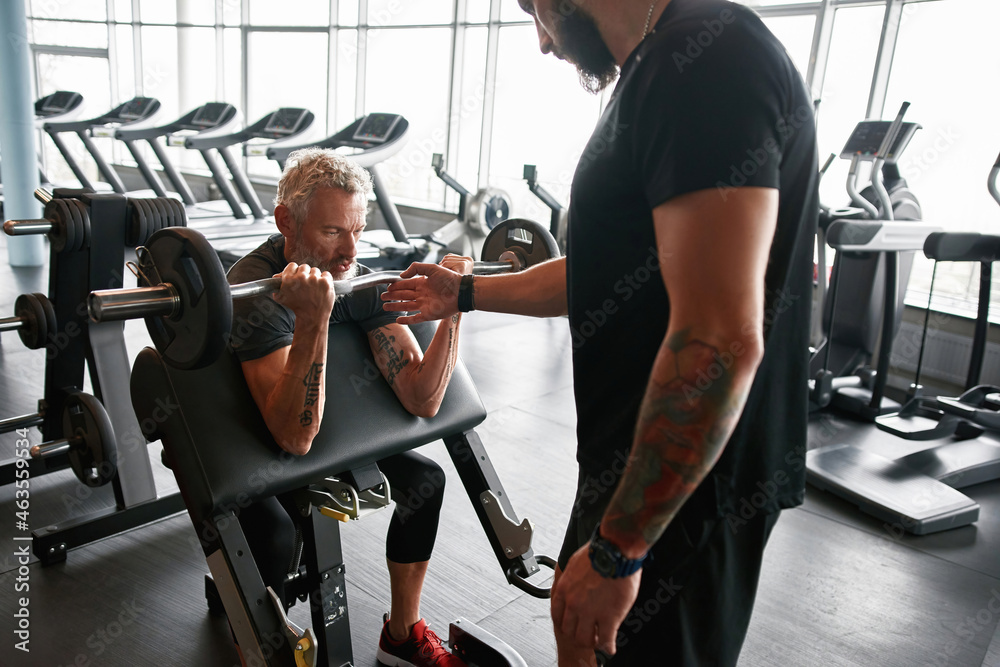 Coach with elder client in gym Stock Photo | Adobe Stock