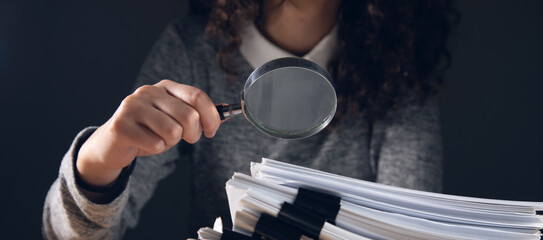 Wall Mural - woman holding magnifying glass and documents