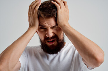 emotional man in a white t-shirt headache migraine problems isolated background