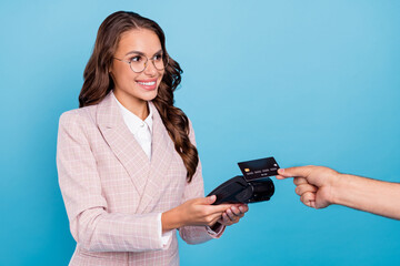 Sticker - Portrait of attractive cheerful woman seller using bank card terminal customer service isolated over bright blue color background