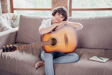 Canvas Print - Photo of sweet brunette millennial lady play guitar wear white shirt jeans sit at home alone