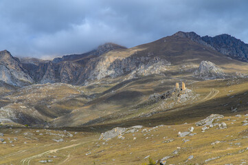 Mountain landscape and a road leading up to two old dilapidated watchtowers