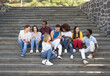 © Alessandro Biascioli - Young multiracial group of friends using mobile smartphone sitting on stairs out of college - Youth millennial lifestyle concept