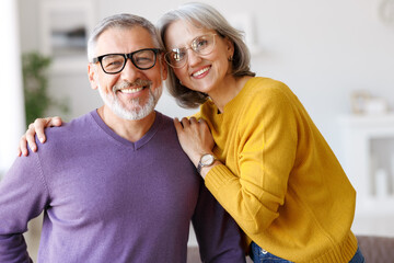 Portrait of happy beautiful senior caucasian family couple in love smiling at camera at home