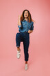 © Drobot Dean - European ginger woman in jeans smiling and making winner gesture