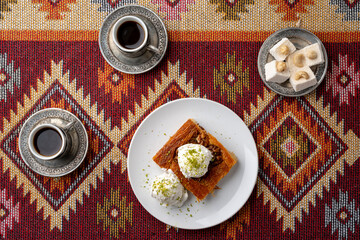 Wall Mural - Turkish coffee and sweets served on colorful patterned carpet