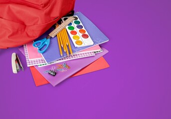 Wall Mural - Backpack with colorful school supplies on the background. Back to school.