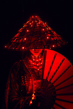 Anonymous Woman In Traditional Vietnamese Apparel With Red Lights