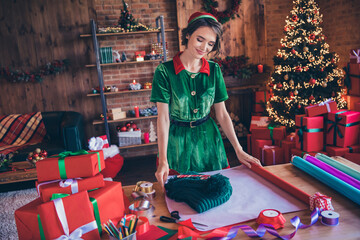 Photo of young cheerful positive santa helper woman make present wrap assistant indoors inside house home