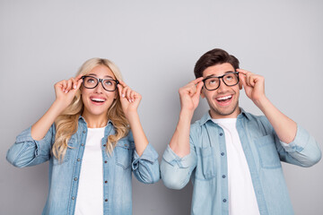 Sticker - Photo of young couple happy positive smile hands touch eyeglasses vision look empty space isolated over grey color background