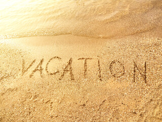 Wall Mural - The word Vacation is written on the beach