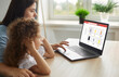 © Studio Romantic - Young ladies enjoying online shopping. Mother and child buying new tops in Internet family clothing store. Happy mom and daughter picking items in fashion outlet with good discounts and free delivery
