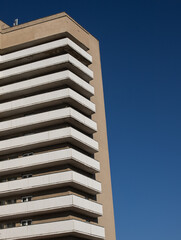 Modern architecture geometry against a clear, blue sky. Minimalist aesthetics. Geometric colored shapes of architecture. Place for text.