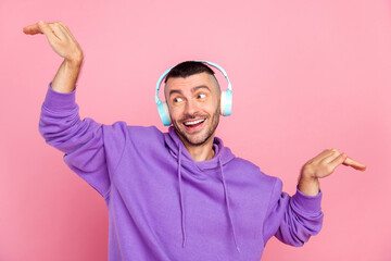 Wall Mural - Photo of cute young brunet guy listen music look wear eyewear hoodie isolated on pink background