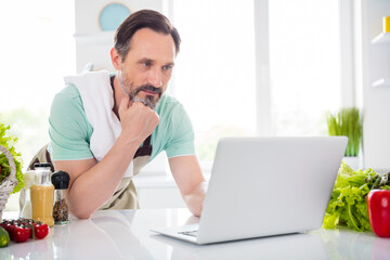 Poster - Photo of focused concentrated man look screen netbook cook lesson wear apron blue t-shirt home kitchen indoors