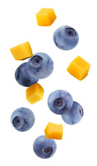 Wall Mural - falling blueberries and mango isolated on white background.