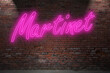 Neon BDSM Martinet (in german Zuchtmeister) lettering on Brick Wall at night