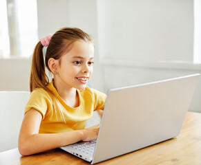 Wall Mural - child laptop computer technology home girl education homework kid learning internet childhood student sitting connection using online