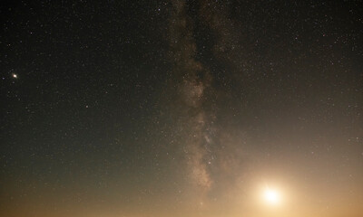Wall Mural - Beautiful bright milky way galaxy with long exposure cloud on the blue starry sky  and moon. Space, astronomical background. Cosmos wallpaper.