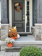 © Joanne Dale - Colourful pumpkins, gourds and mums create a luxury thanksgiving landscaping decor at a front entrance.