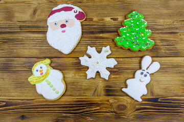 Wall Mural - Christmas gingerbread cookies on a wooden table. Top view