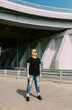 © Alexey Kuzma/Stocksy - Lesbian Woman with sunglasses outdoors