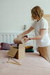 © Sergey Narevskih/Stocksy - Woman packing wear in box