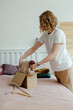 © Sergey Narevskih/Stocksy - Woman packing wear to exchange clothes on Internet