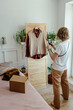 © Sergey Narevskih/Stocksy - Woman taking picture of wardrobe for ad on internet