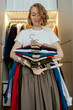 © Sergey Narevskih/Stocksy - Woman decluttering clothes at home