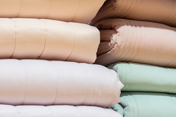 Poster - Colorful folded blanket stack closeup picture.
