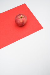 fresh organic agriculture red apple fruit on a red and white surface