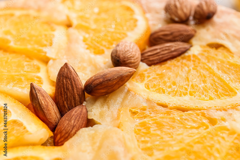 Tasty orange pie with almond nuts, closeup