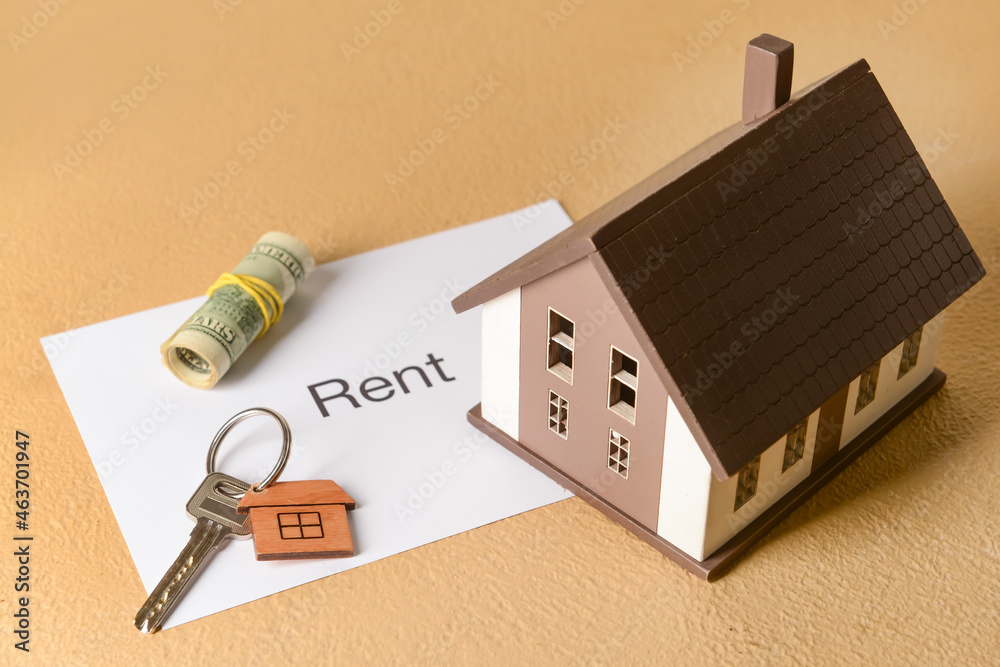 House model with word RENT, key and money on beige background