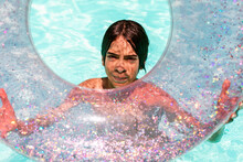 Teenager Showing Transparent Float In Pool